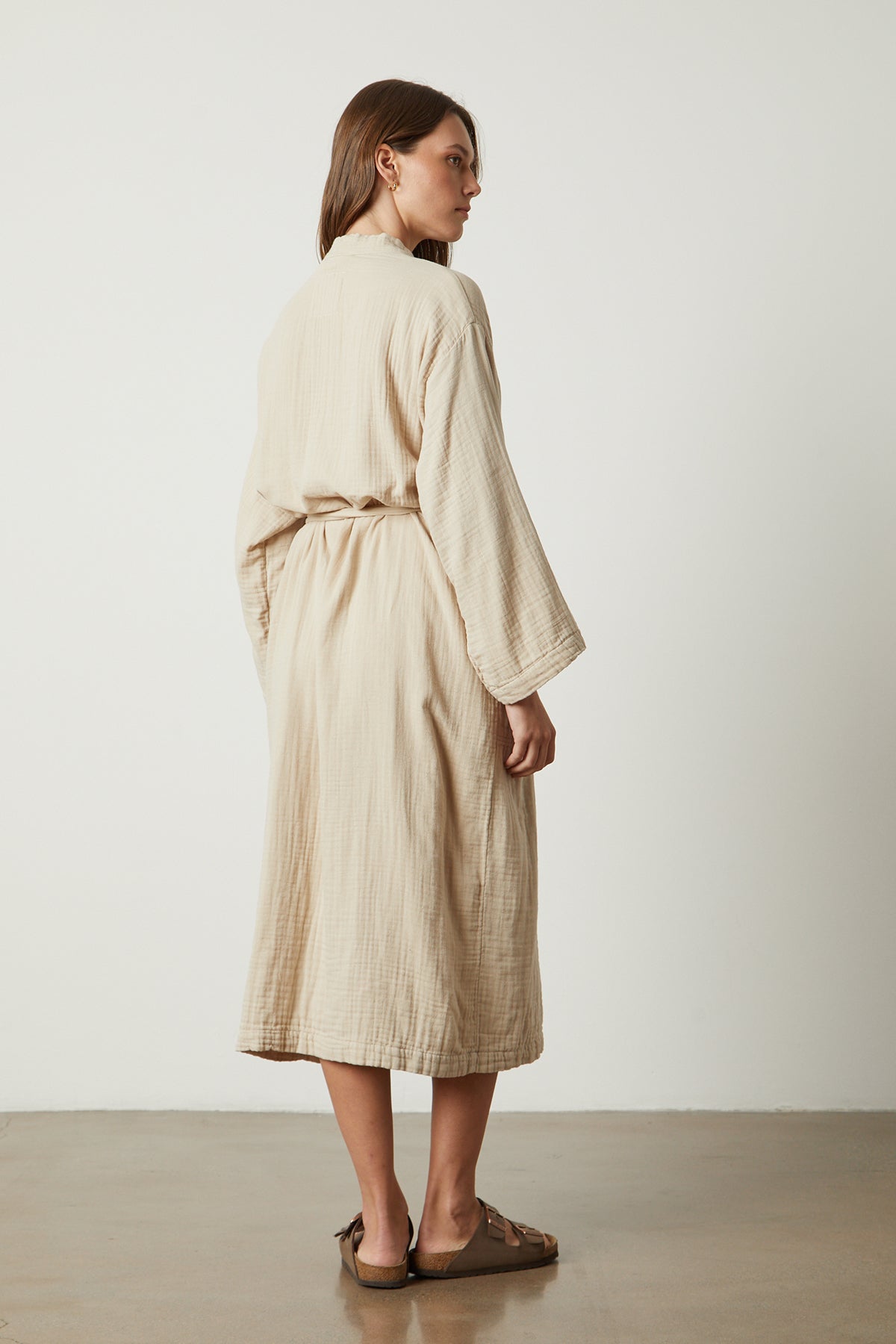   the back view of a woman wearing a Jenny Graham Home COTTON GAUZE ROBE. 