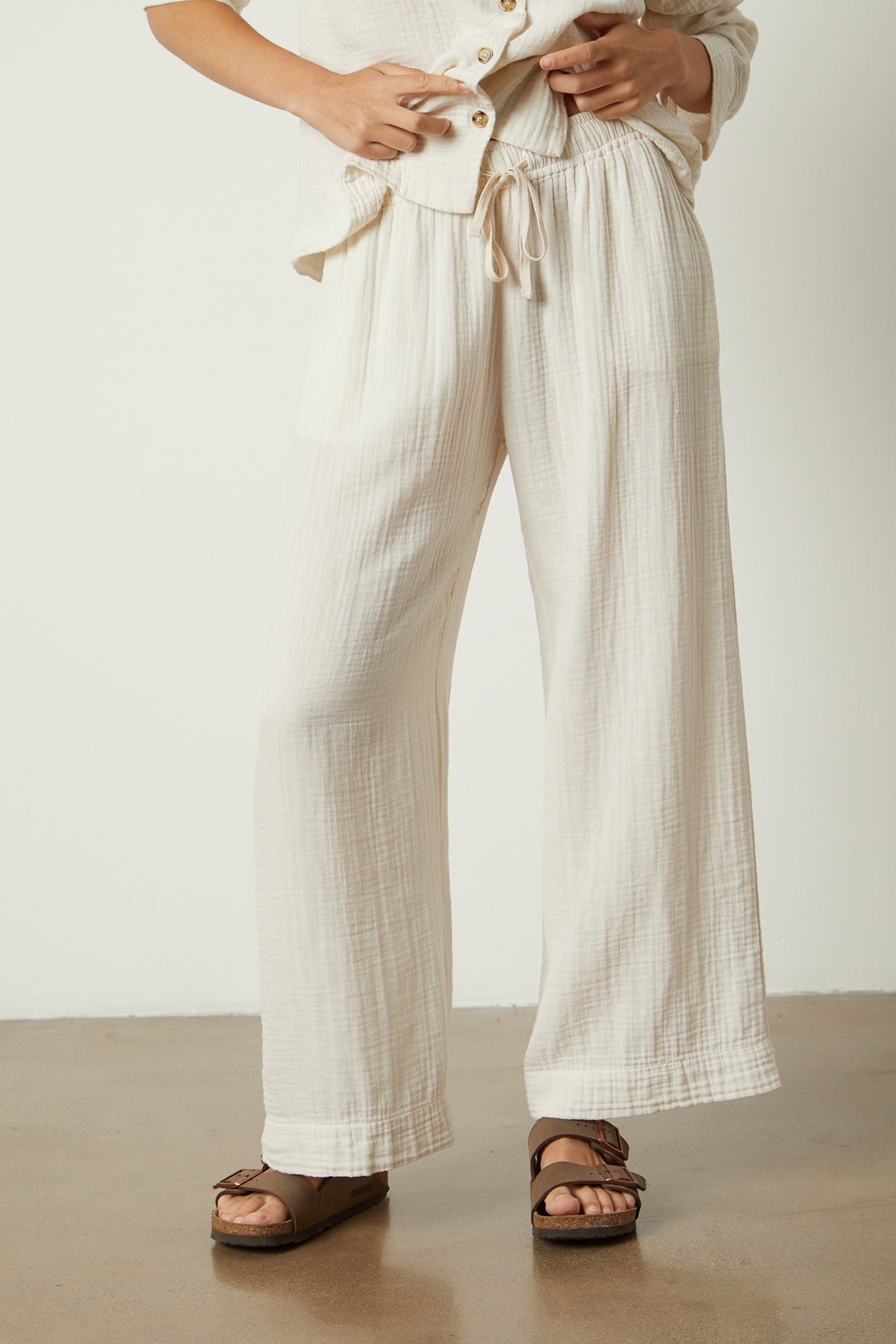   the model is wearing a white blouse and Jenny Graham Home wide leg PAJAMA PANT. 