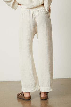 The back view of a woman wearing white wide leg PAJAMA PANTS from Jenny Graham Home.