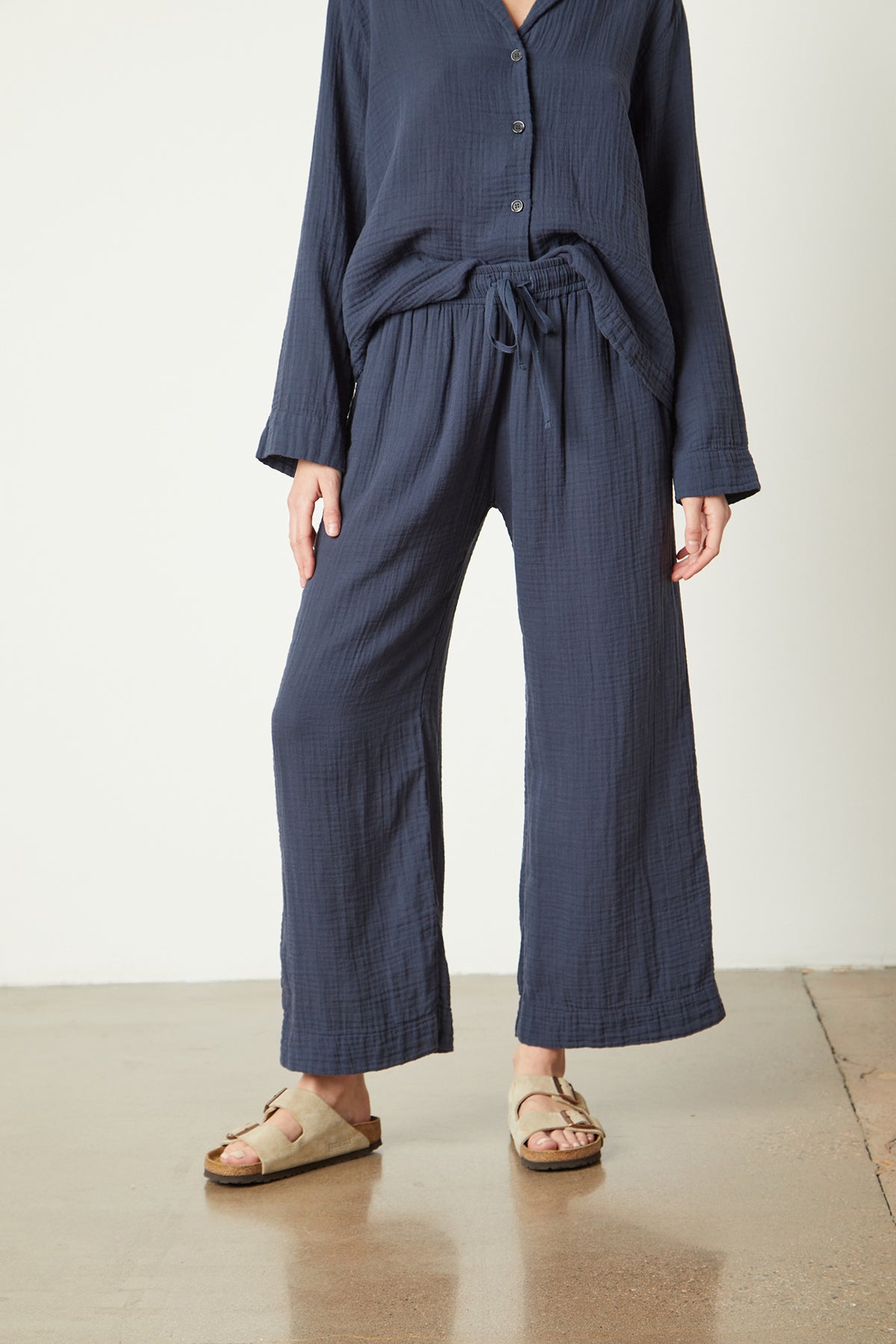 The model is wearing a navy linen PAJAMA PANT and Jenny Graham Home sandals.-25519563243713