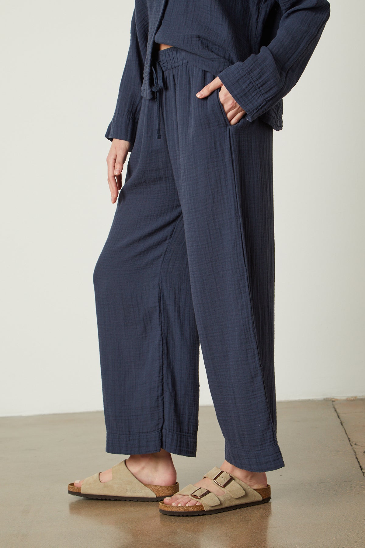   The model is wearing a navy wide leg PAJAMA PANT from Jenny Graham Home and sandals. 