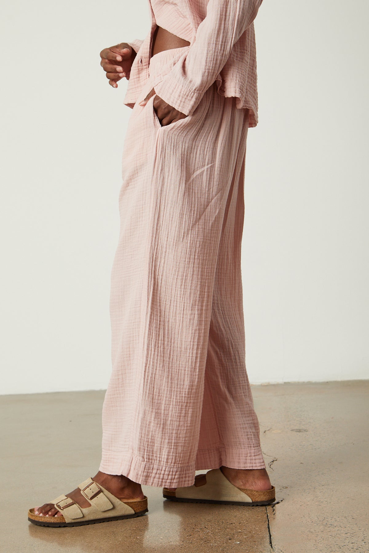 a woman wearing pink wide leg Jenny Graham Home pajama pants and sandals.-25519563440321