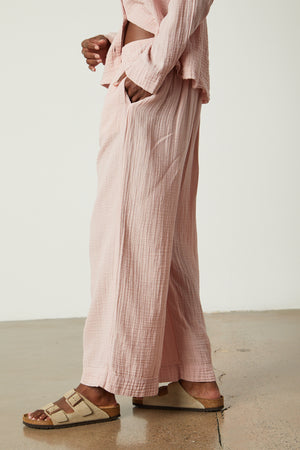 a woman wearing pink wide leg Jenny Graham Home pajama pants and sandals.