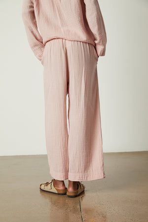 the back of a woman wearing a Jenny Graham Home pink jumpsuit.