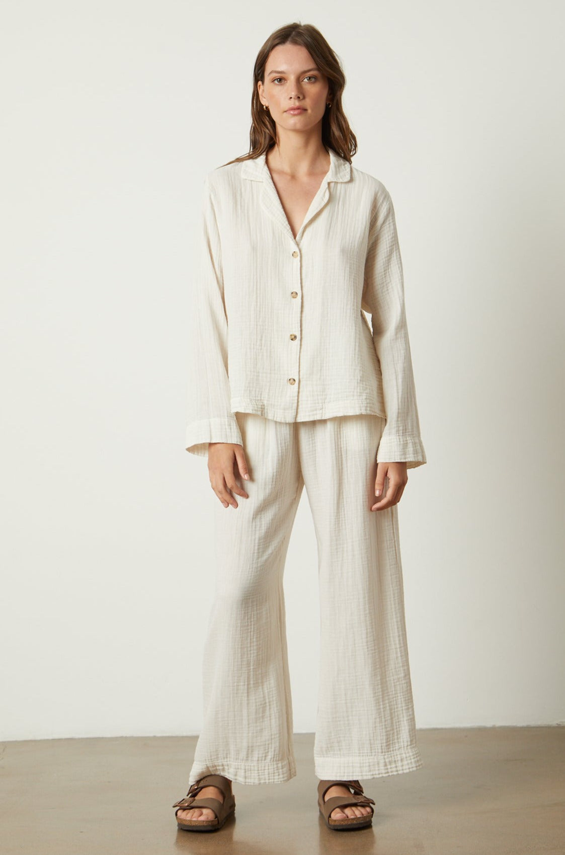 The model is wearing a white linen Jenny Graham Home pajama set.-25519563047105