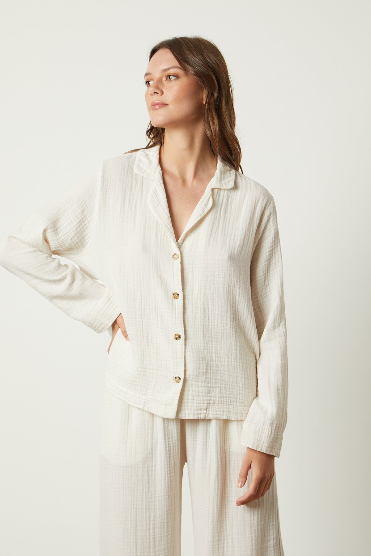   The model is wearing a white Jenny Graham Home pyjama shirt and pants. 