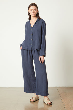 The model is wearing a blue linen shirt and Jenny Graham Home PAJAMA PANT.