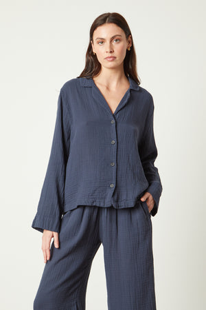 The model is wearing a navy linen PAJAMA SHIRT from Jenny Graham Home and wide leg pants.