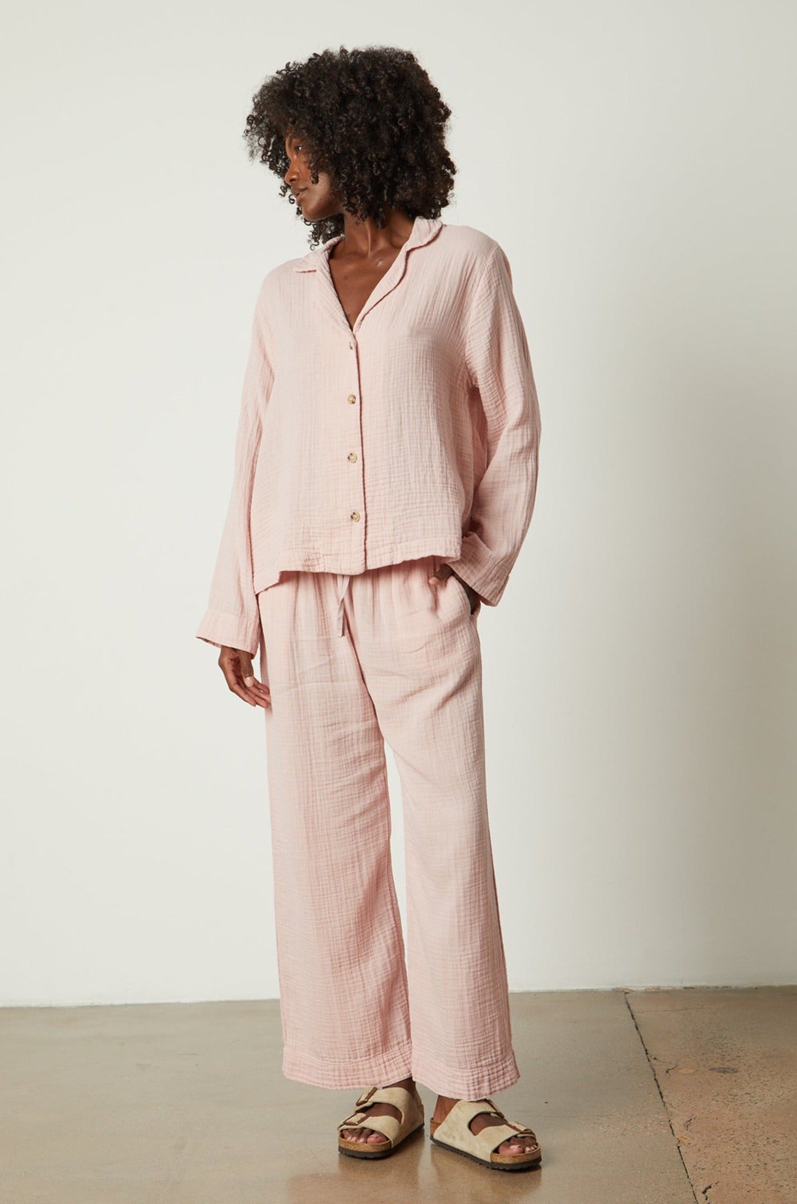   The model is wearing a pink linen pajama pant set from Jenny Graham Home. 