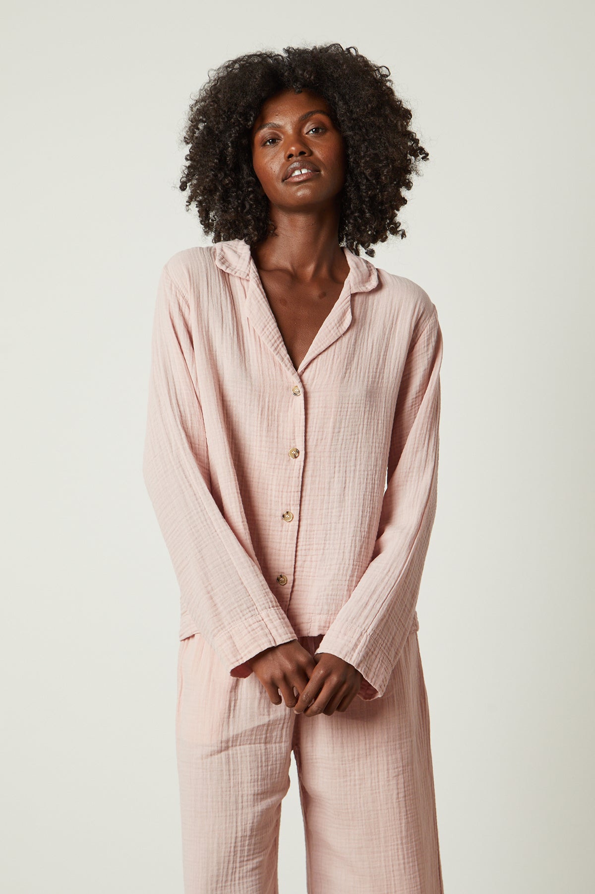   The model is wearing a pink Jenny Graham Home pajama shirt. 