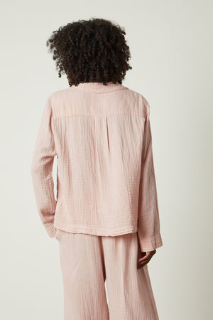 the back view of a woman wearing a pink Jenny Graham Home PAJAMA SHIRT and pants.