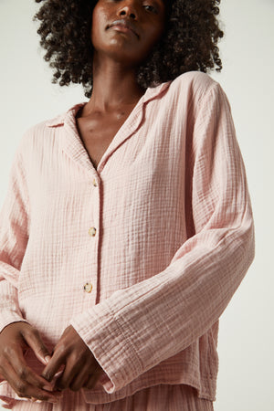 The model is wearing a Jenny Graham Home pink pajama shirt.
