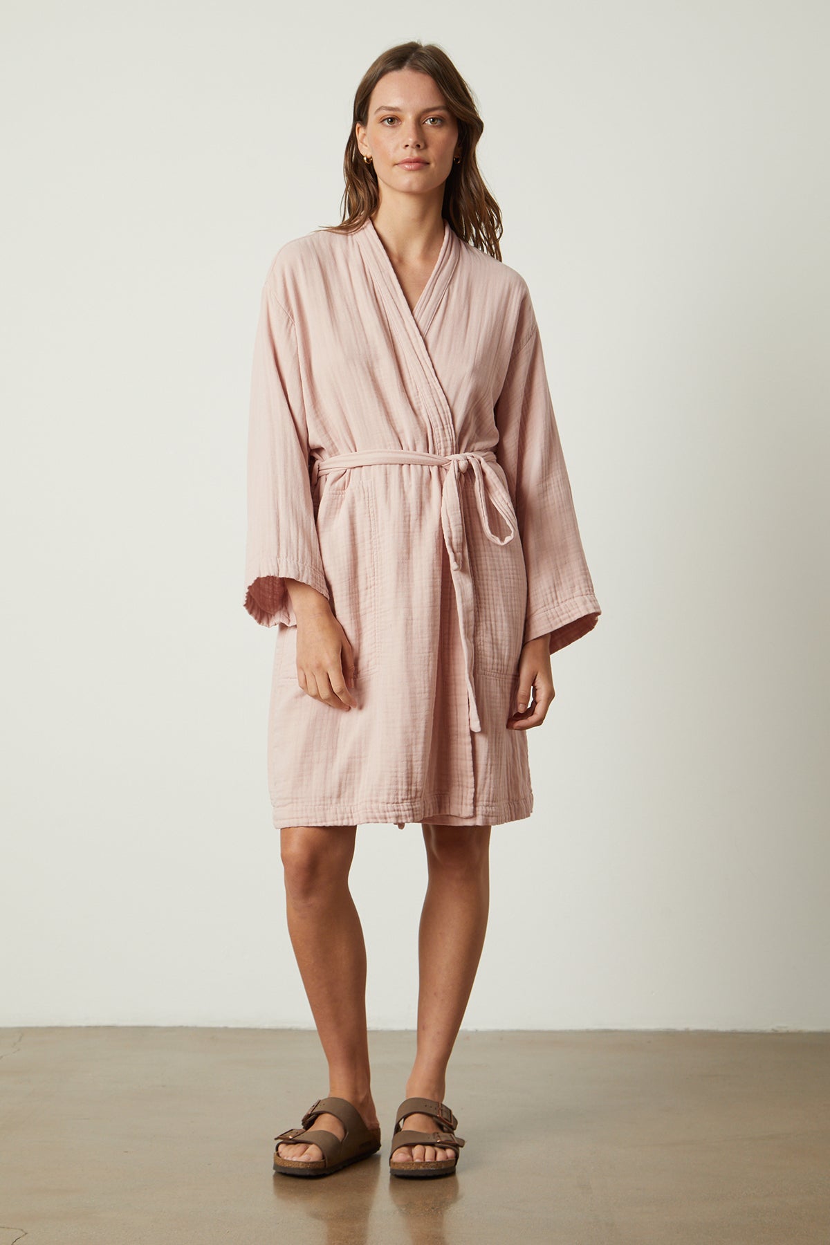   A woman wearing a MINI COTTON GAUZE ROBE from Jenny Graham Home. 