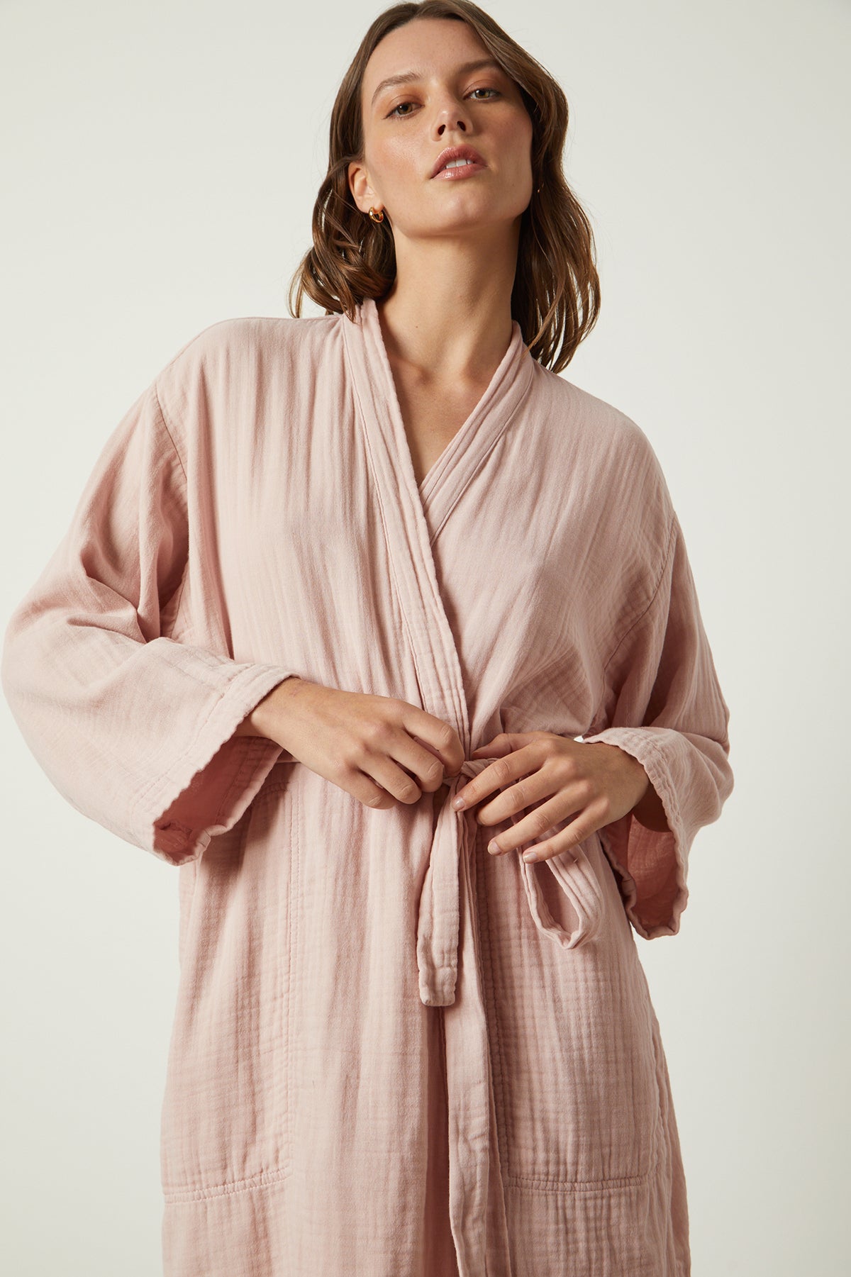   The model is wearing a soft texture, mini thigh-length version of a Jenny Graham Home Mini Cotton Gauze Robe. 
