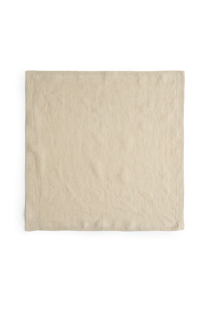 A beige linen napkin with a luxe finish on a white background from Jenny Graham Home.
