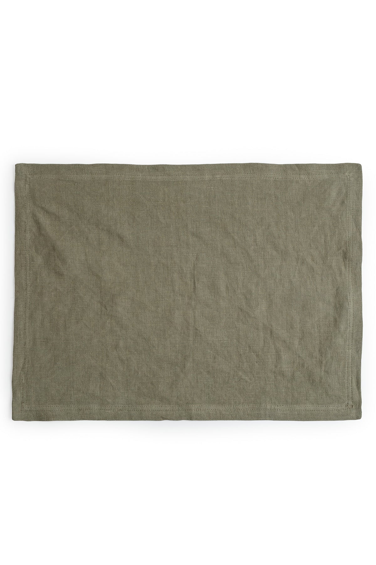  A plain green dyed Jenny Graham Home linen placemat displayed on a white background. 