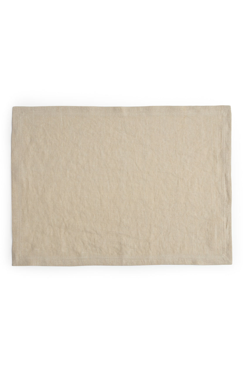 A beige linen placemat by Jenny Graham Home to accessorize a table.