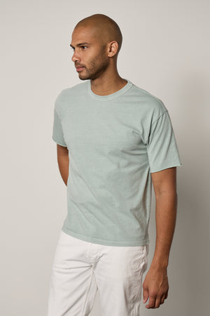 Man facing front wearing Beau Tee in mint green with white denim