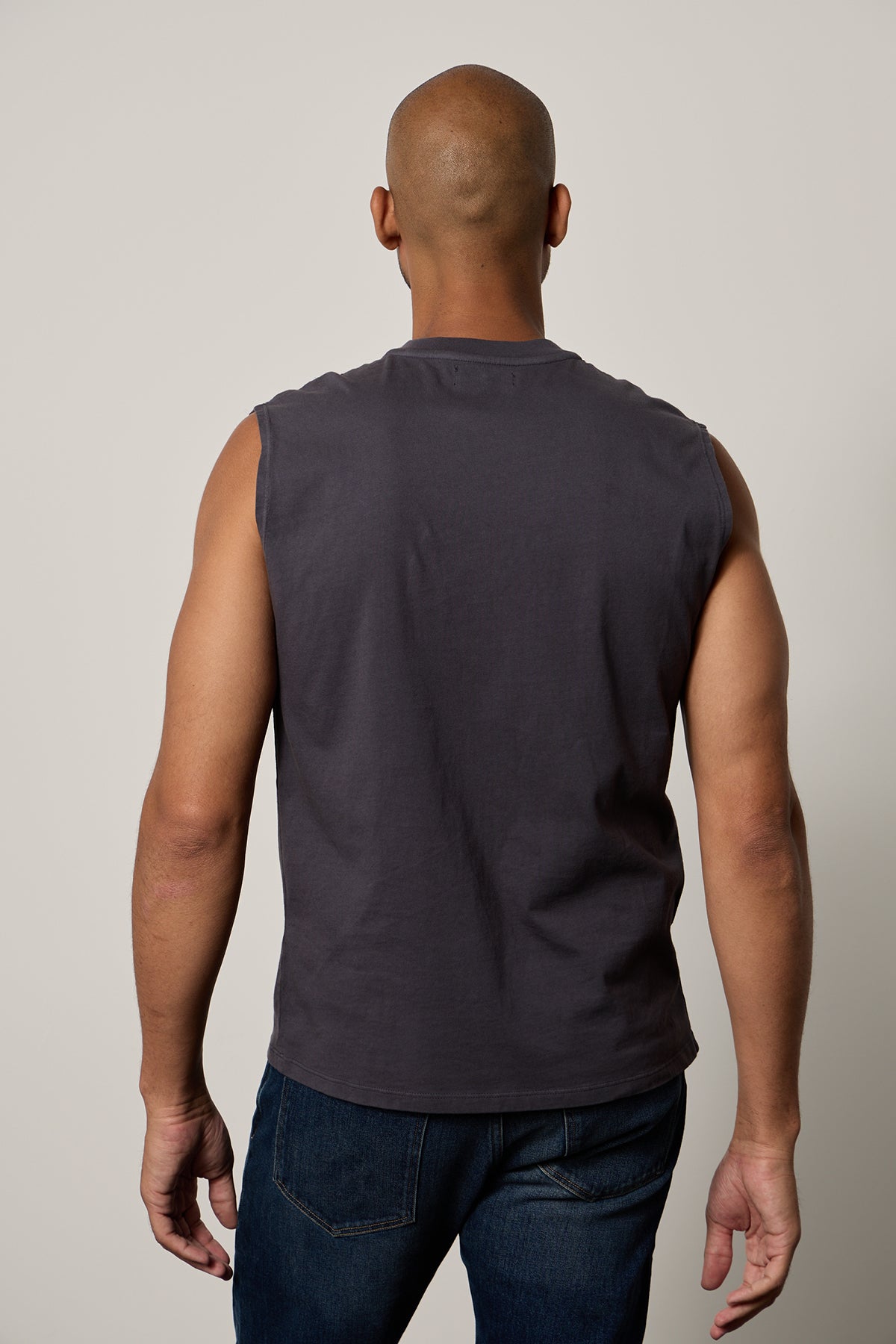 The back view of a man wearing a Velvet by Graham & Spencer LAYNE CREW NECK MUSCLE TEE-26266402062529