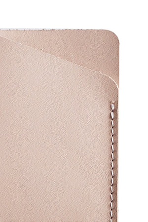 A beige SOFT LEATHER CARD HOLDER BY LIMA SAGRADA with a minimalist zipper, crafted by local artisans.