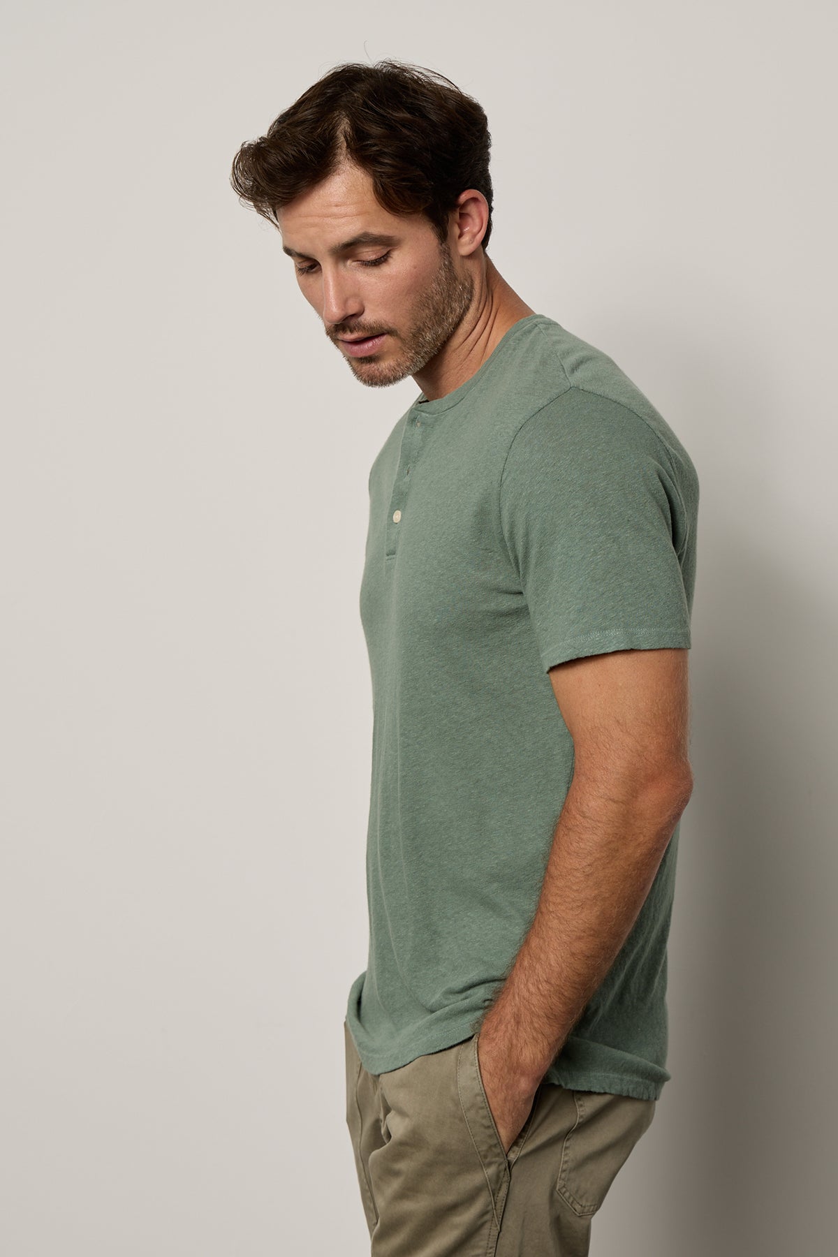   Man wearing Lionel Henley in fern green side view with hands in pants pocket 