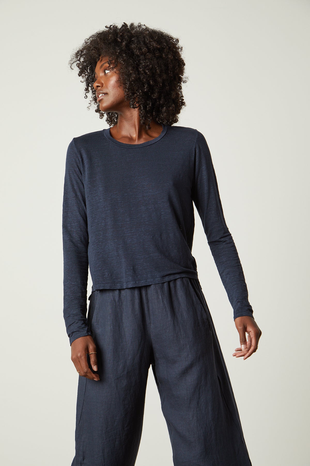 The model is wearing a lightweight KARA CREW NECK TEE and wide-leg pants from Velvet by Graham & Spencer.-26022696812737