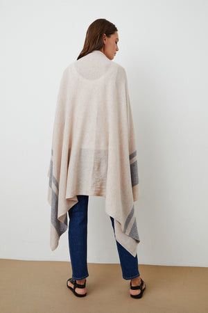 The back view of a woman wearing a Jenny Graham Home LIV Cashmere Throw Blanket.