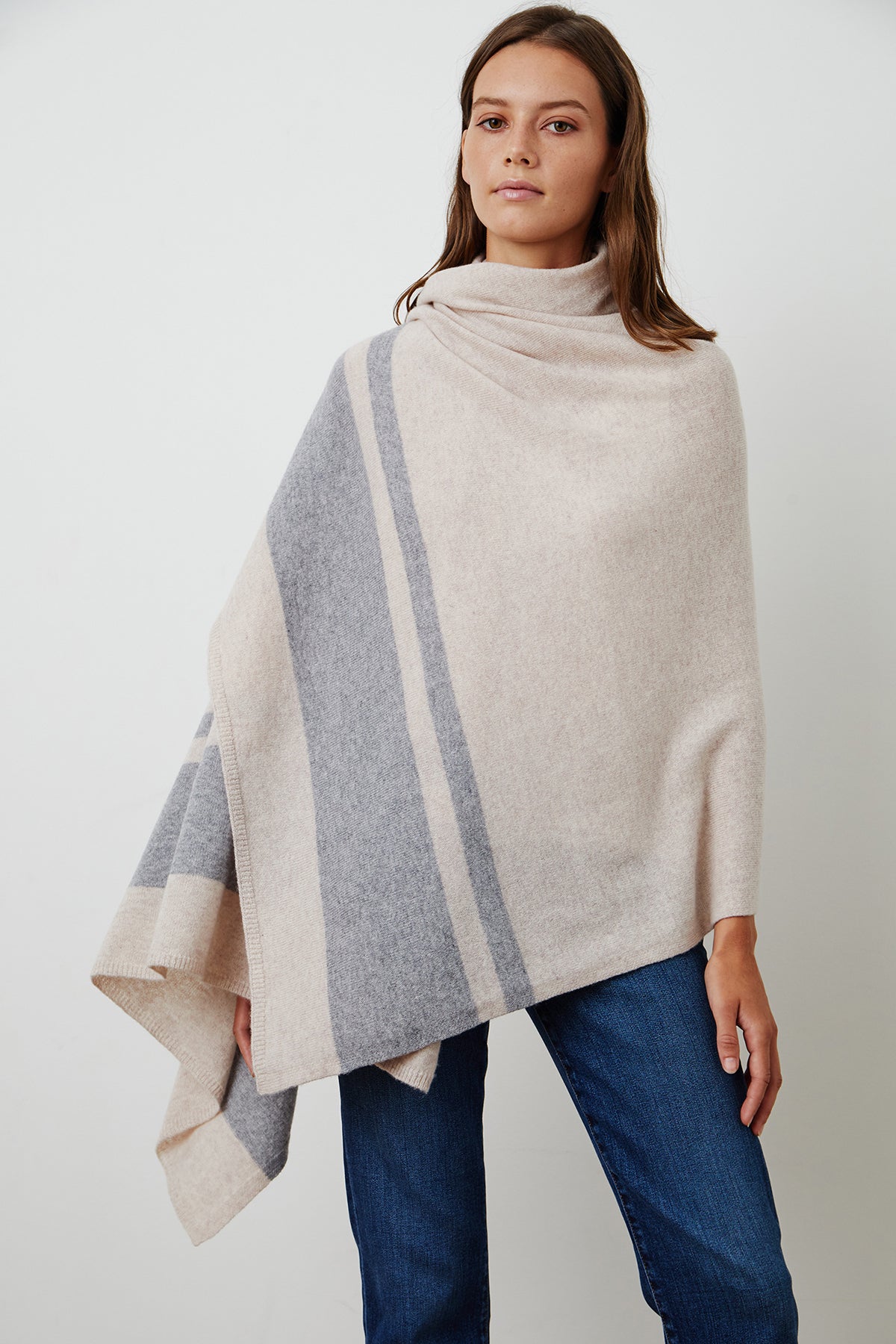 A cozy woman wearing a Jenny Graham Home LIV Cashmere Throw Blanket.-15230754160833