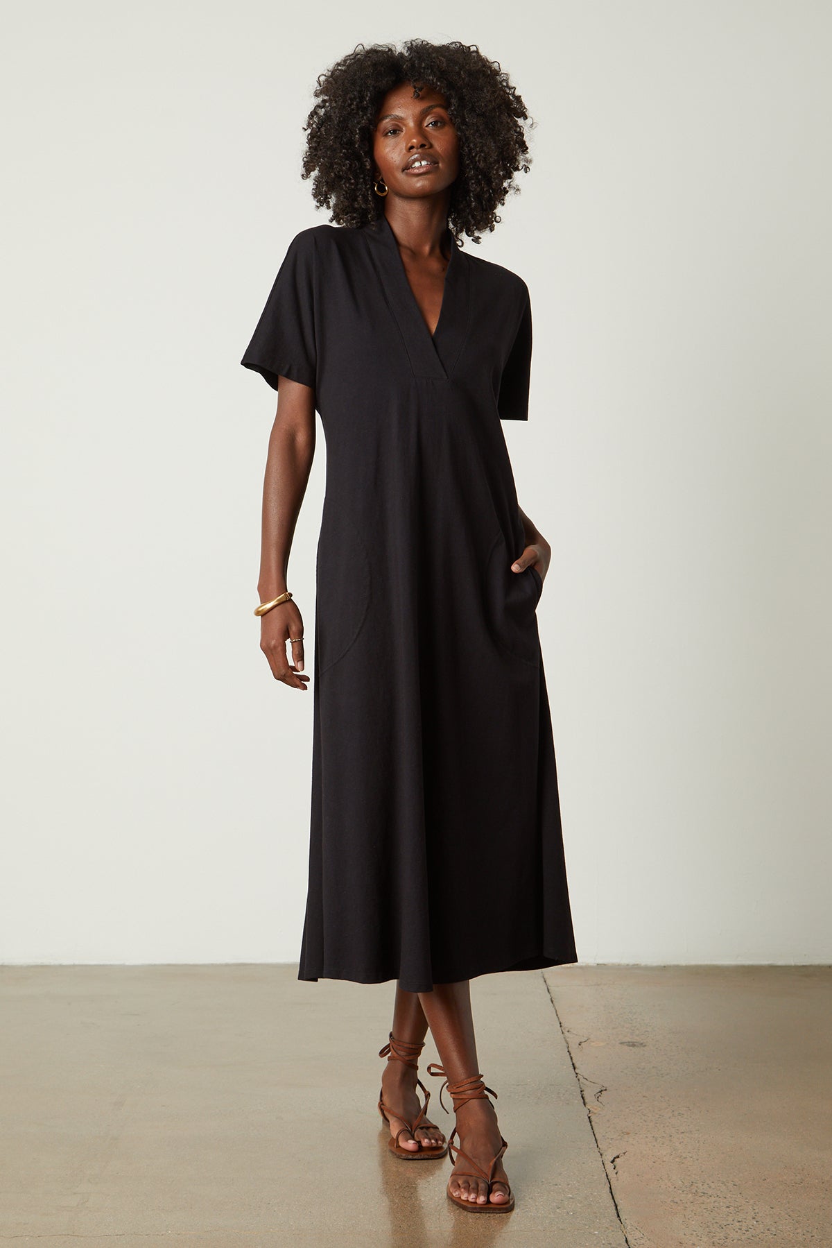 a woman wearing a black Velvet by Graham & Spencer NORA STRUCTURED DRESS and sandals.-26143079661761