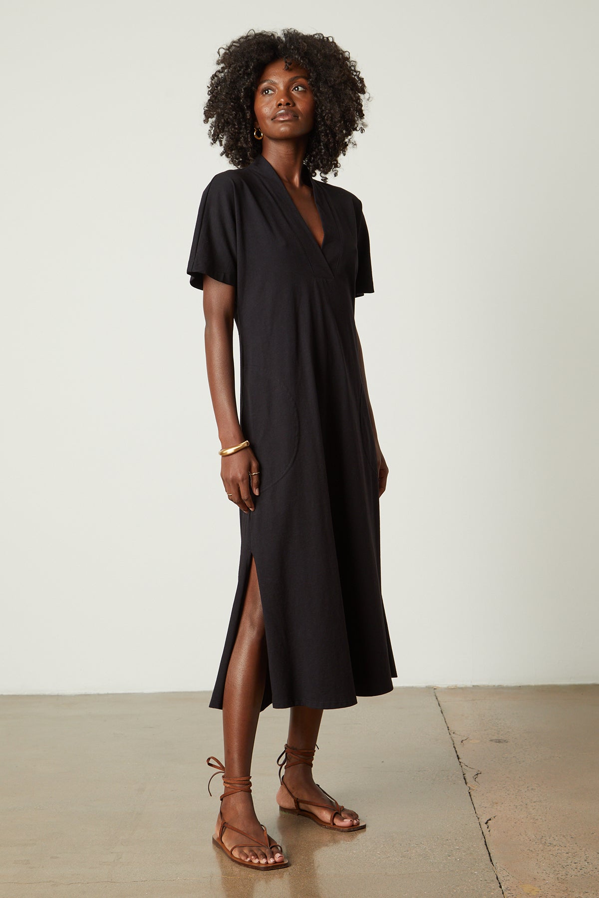   a woman wearing a Velvet by Graham & Spencer NORA STRUCTURED DRESS and sandals. 