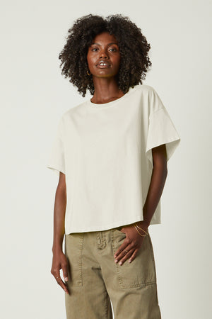 The model is wearing a Rachelle oversized crew neck tee by Velvet by Graham & Spencer and khaki pants.
