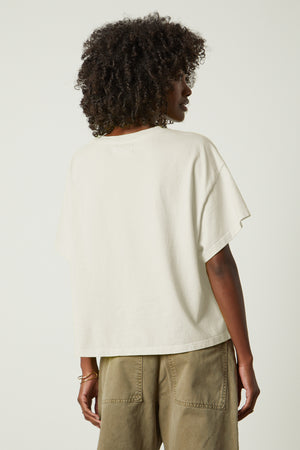 The back view of a woman wearing the Velvet by Graham & Spencer RACHELLE OVERSIZED CREW NECK TEE.