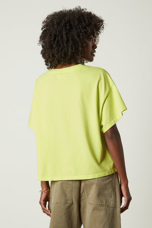 the back view of a woman wearing a Velvet by Graham & Spencer RACHELLE OVERSIZED CREW NECK TEE.