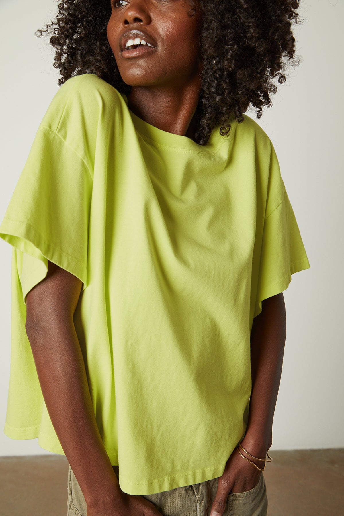A black woman wearing a Velvet by Graham & Spencer Rachelle Oversized Crew Neck Tee t-shirt.-26182403784897