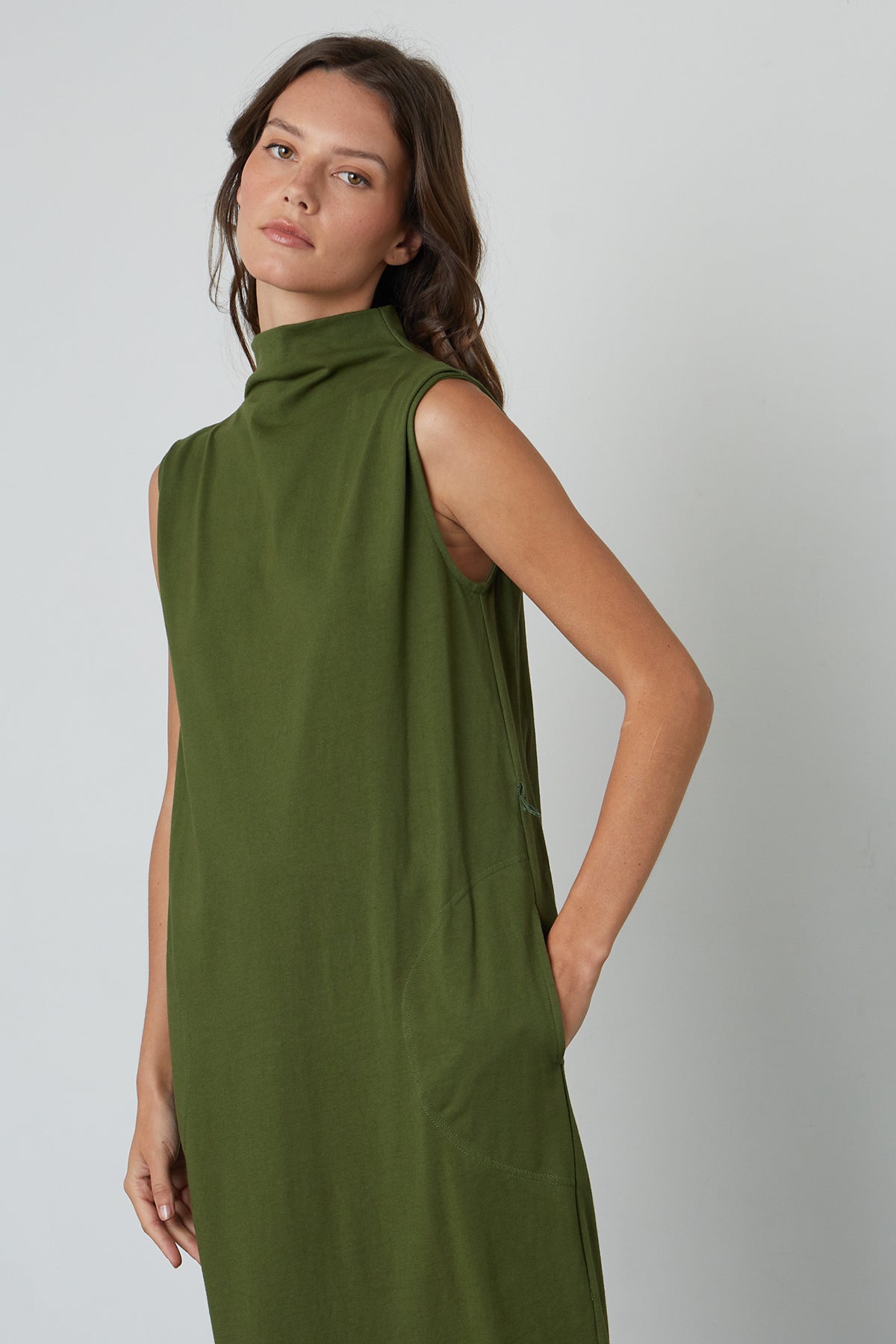   The model is wearing a green Velvet by Graham & Spencer Hydie Mock Neck Dress. 