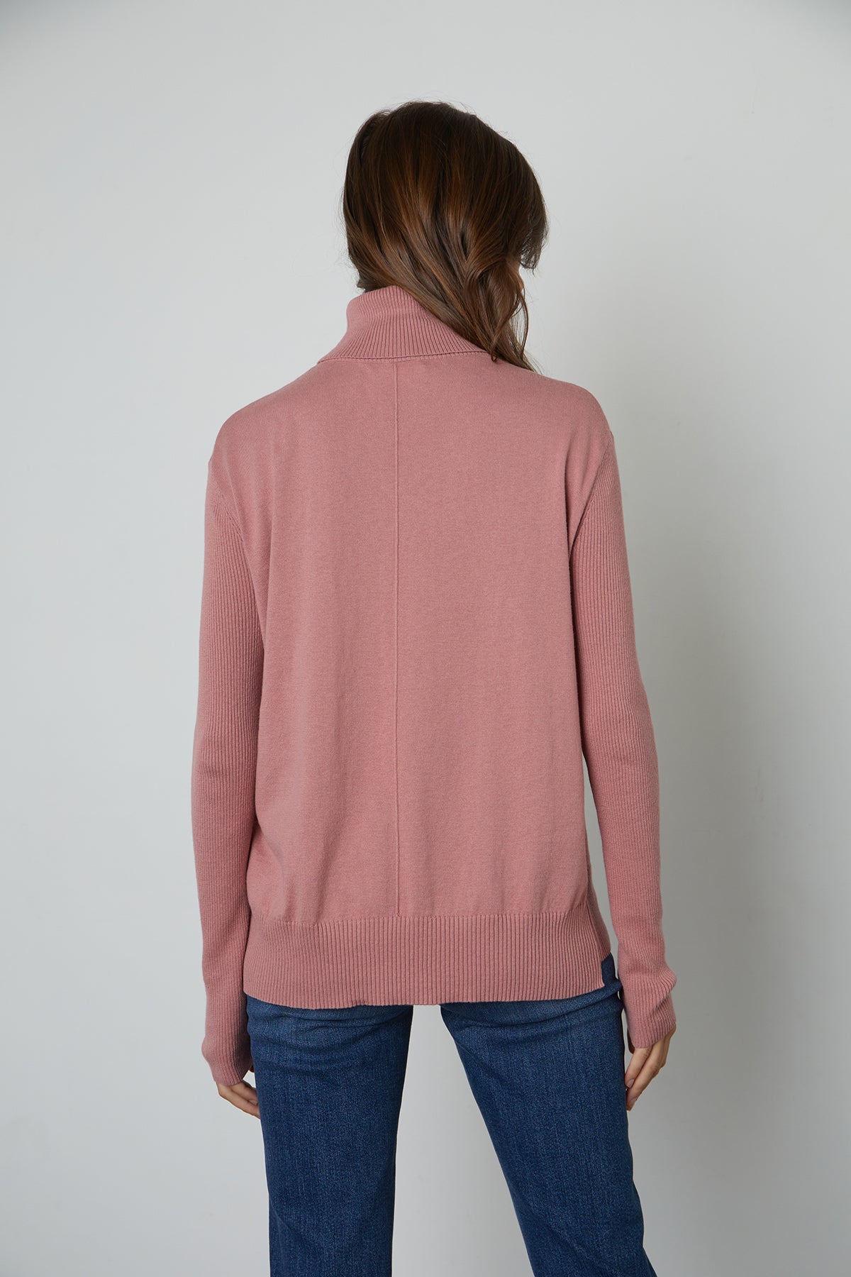   The back view of a woman wearing a Velvet by Graham & Spencer RENNY TURTLENECK SWEATER is perfect for fall layering. 