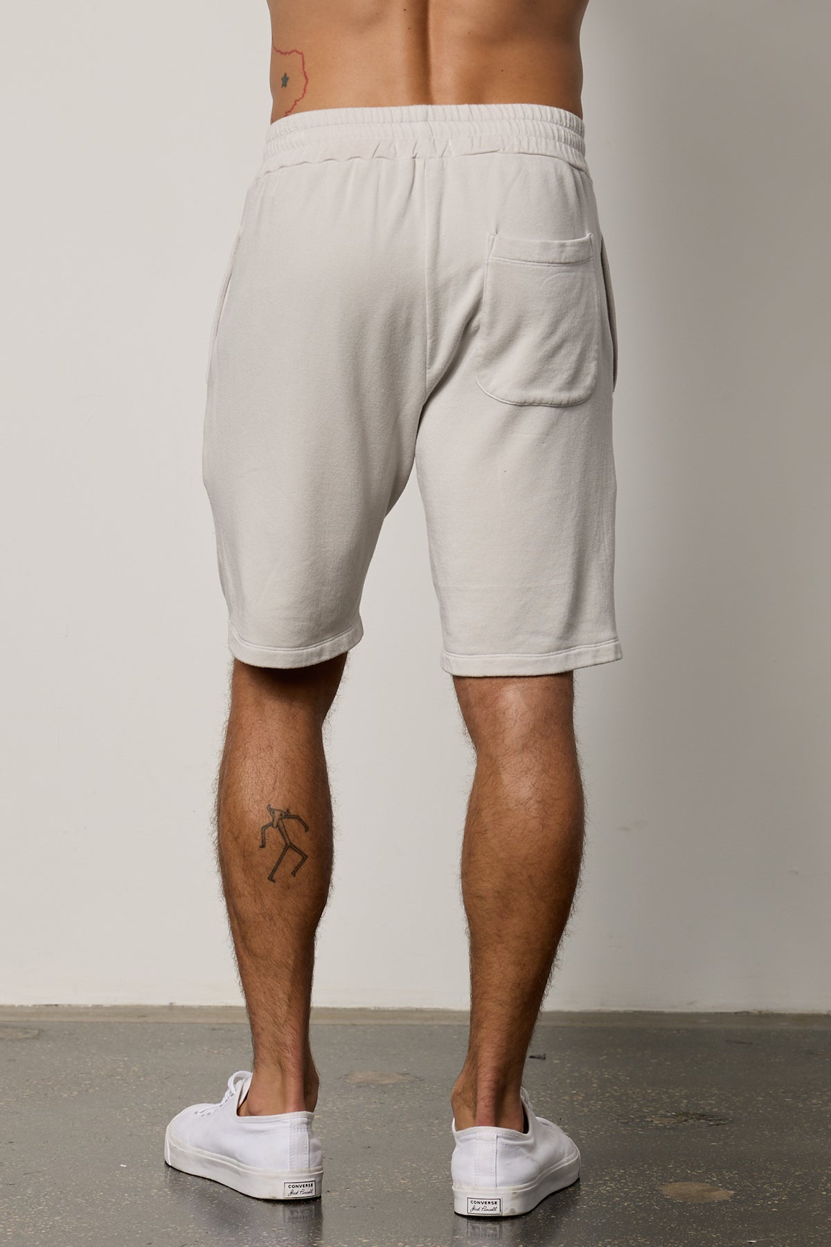 The ATLAS LUXE FLEECE DRAWSTRING SHORT by Velvet by Graham & Spencer create a timeless look for the back view of a man wearing grey sweat shorts.-26079123701953