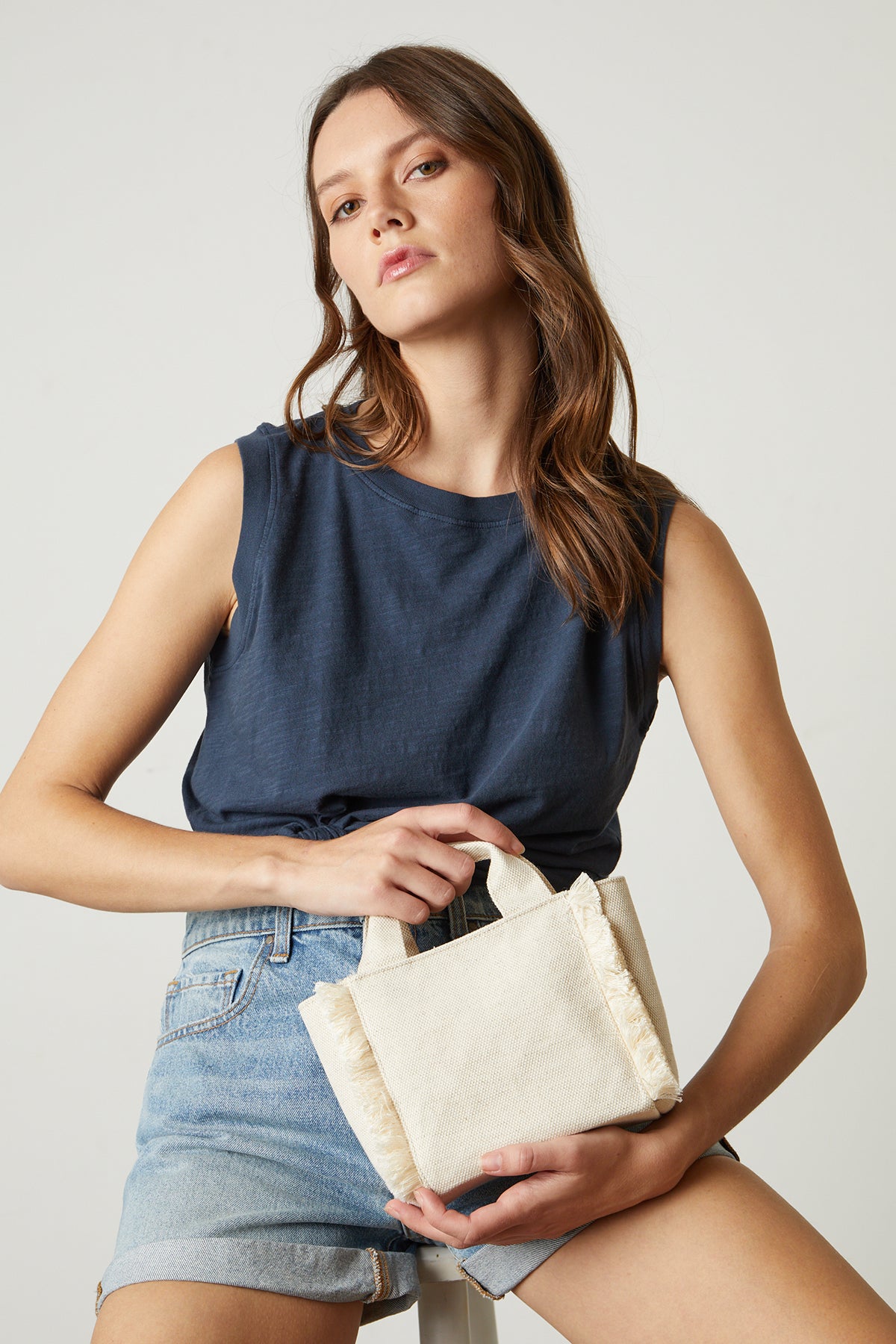 Mini Launch canvas tote in natural with model wearing navy tank and denim shorts-24659129237697