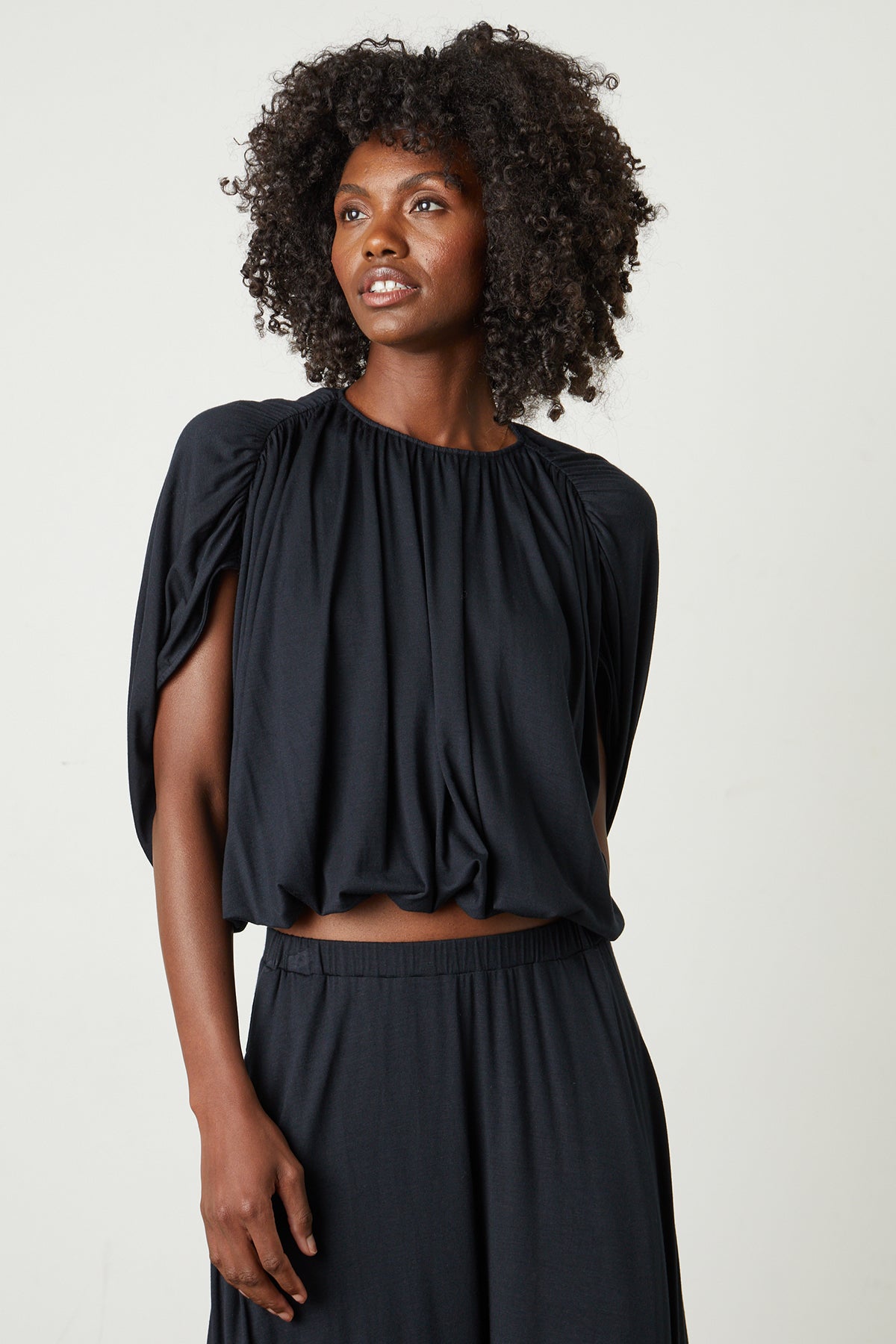   Carmen Cocoon Drape Top in black with Malaya skirt in black front 