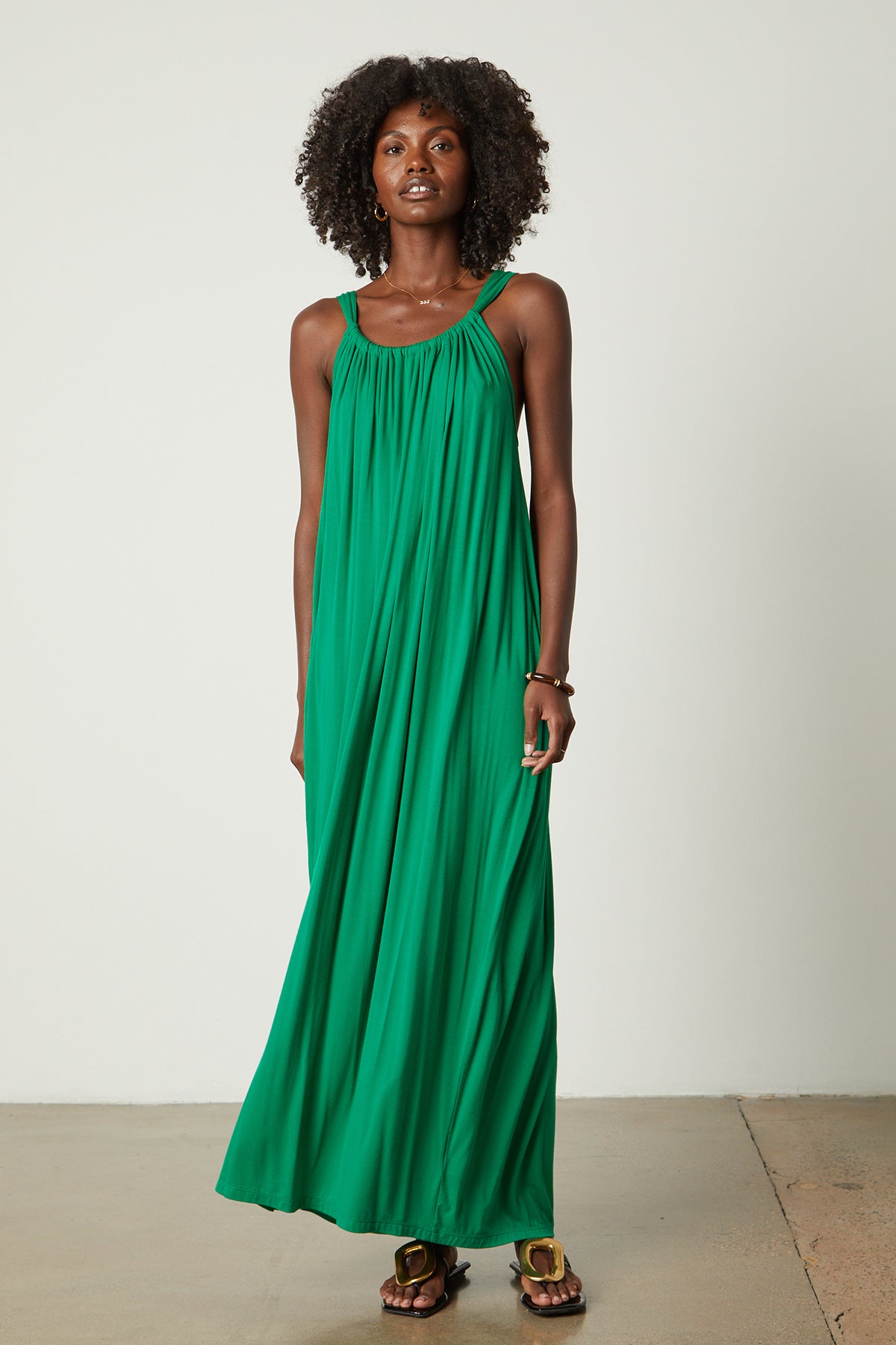   a woman wearing a CHEYENNE TANK MAXI DRESS by Velvet by Graham & Spencer. 