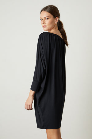 the back view of a woman wearing a Velvet by Graham & Spencer HOLLIE DRAPE BOAT NECK DRESS.