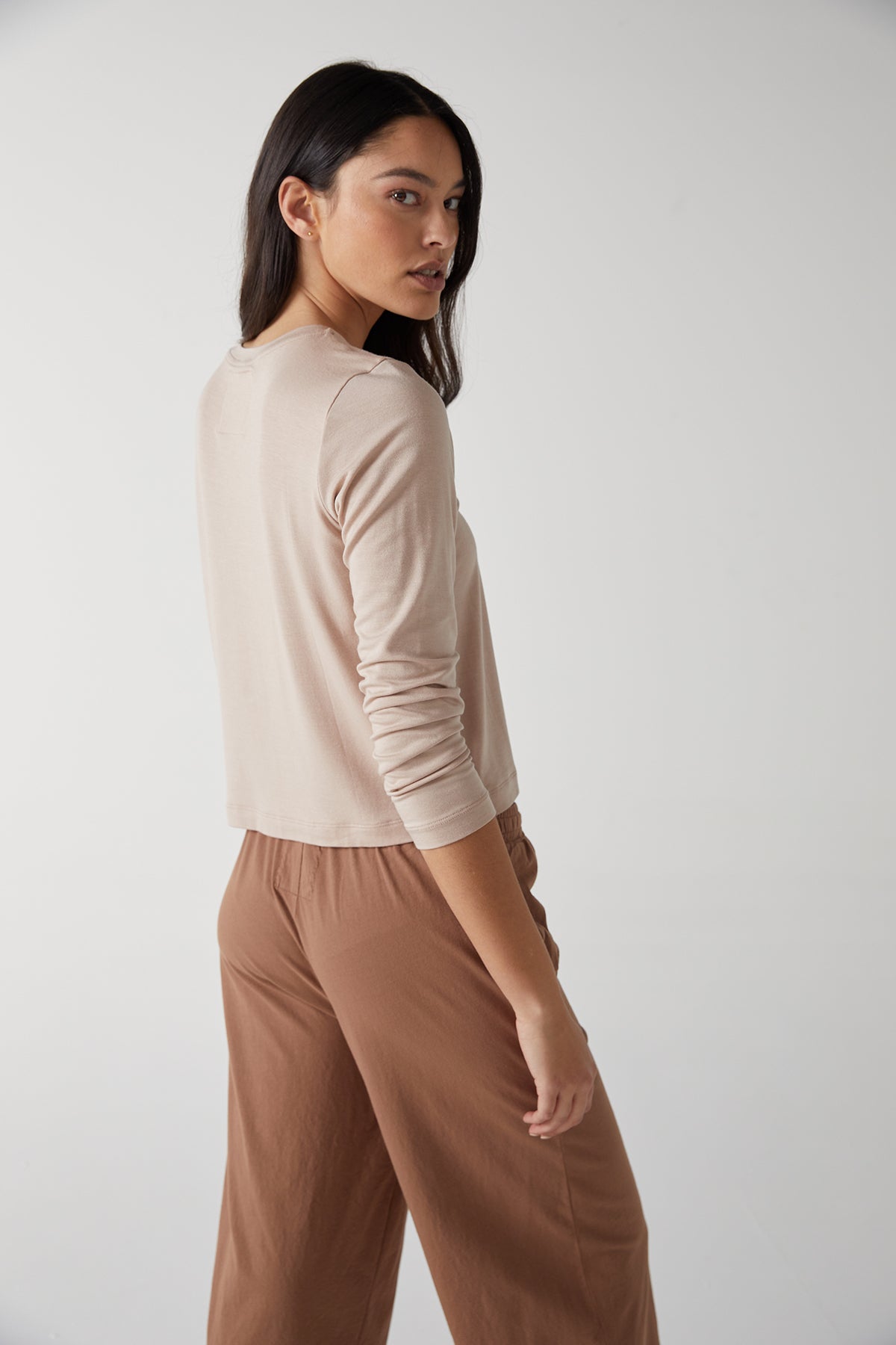 The model is wearing Velvet by Jenny Graham tan wide leg pants and a beige sweater.-25483543445697