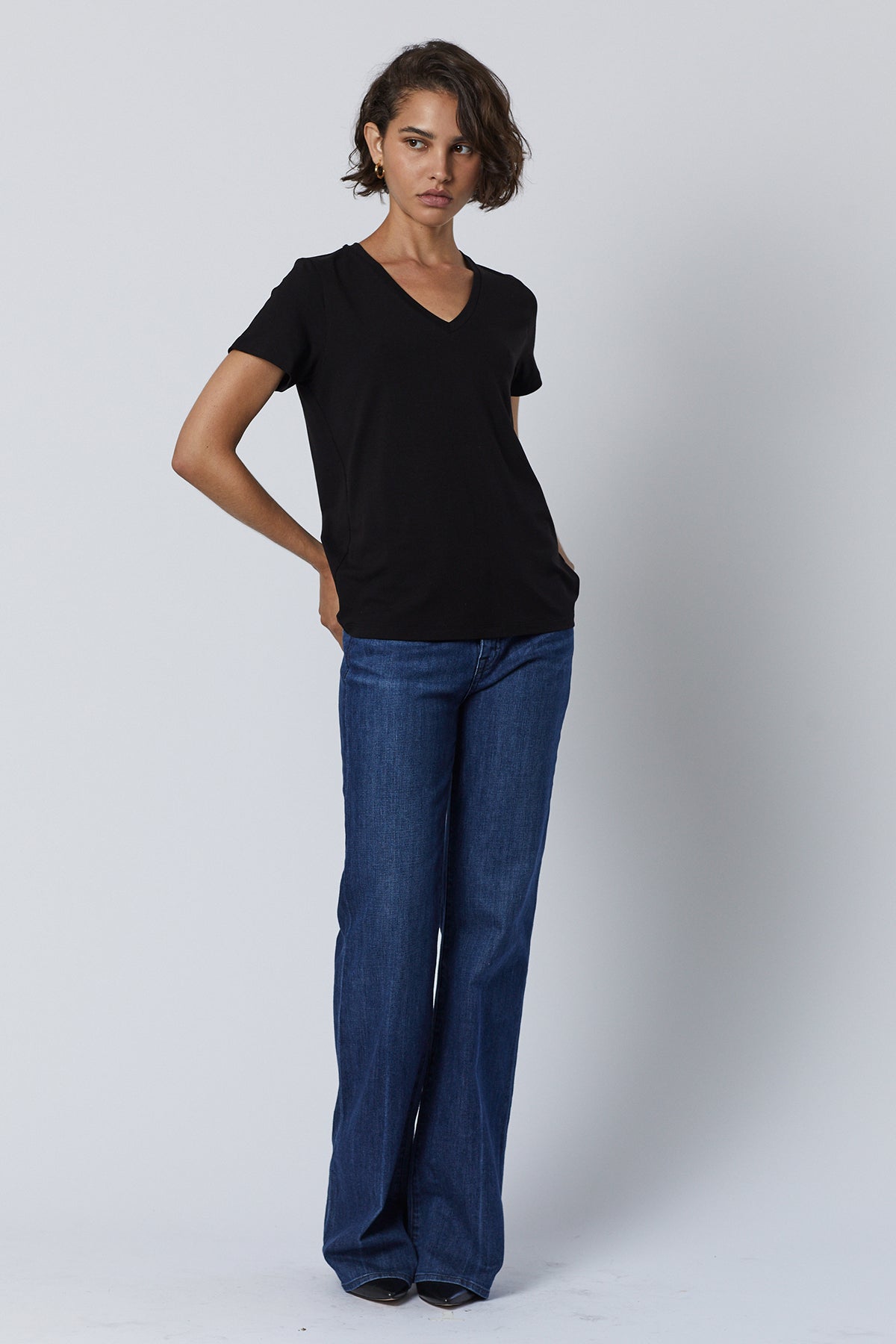 Runyon Tee in black with blue denim and black heels full length front-26007207215297