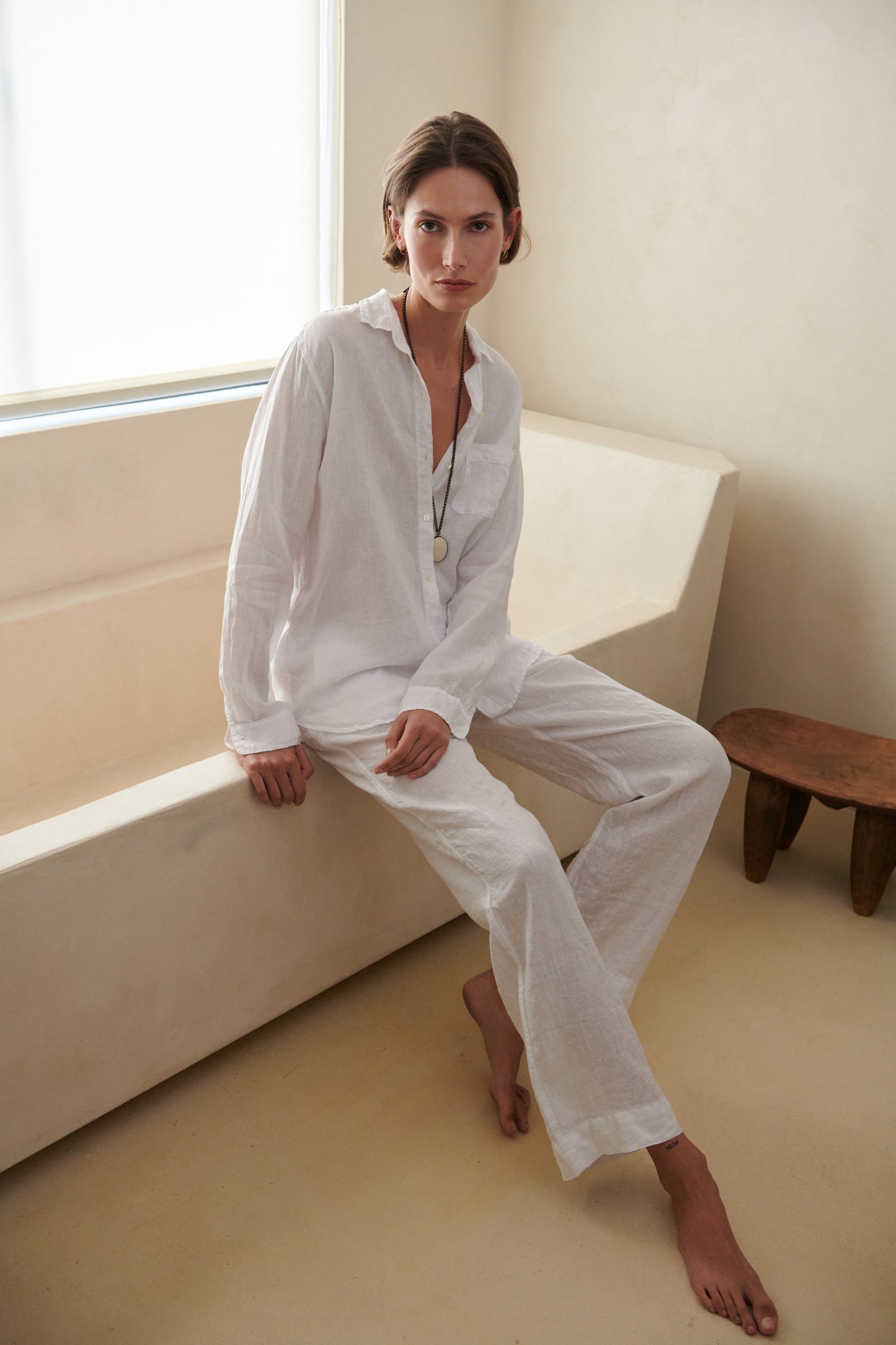 a woman in white Velvet by Jenny Graham PICO PANT sitting on the edge of a bathtub.-26293120696513