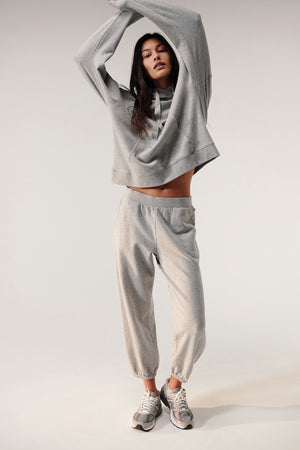 a woman wearing ZUMA SWEATPANT by Velvet by Jenny Graham and a grey hoodie.