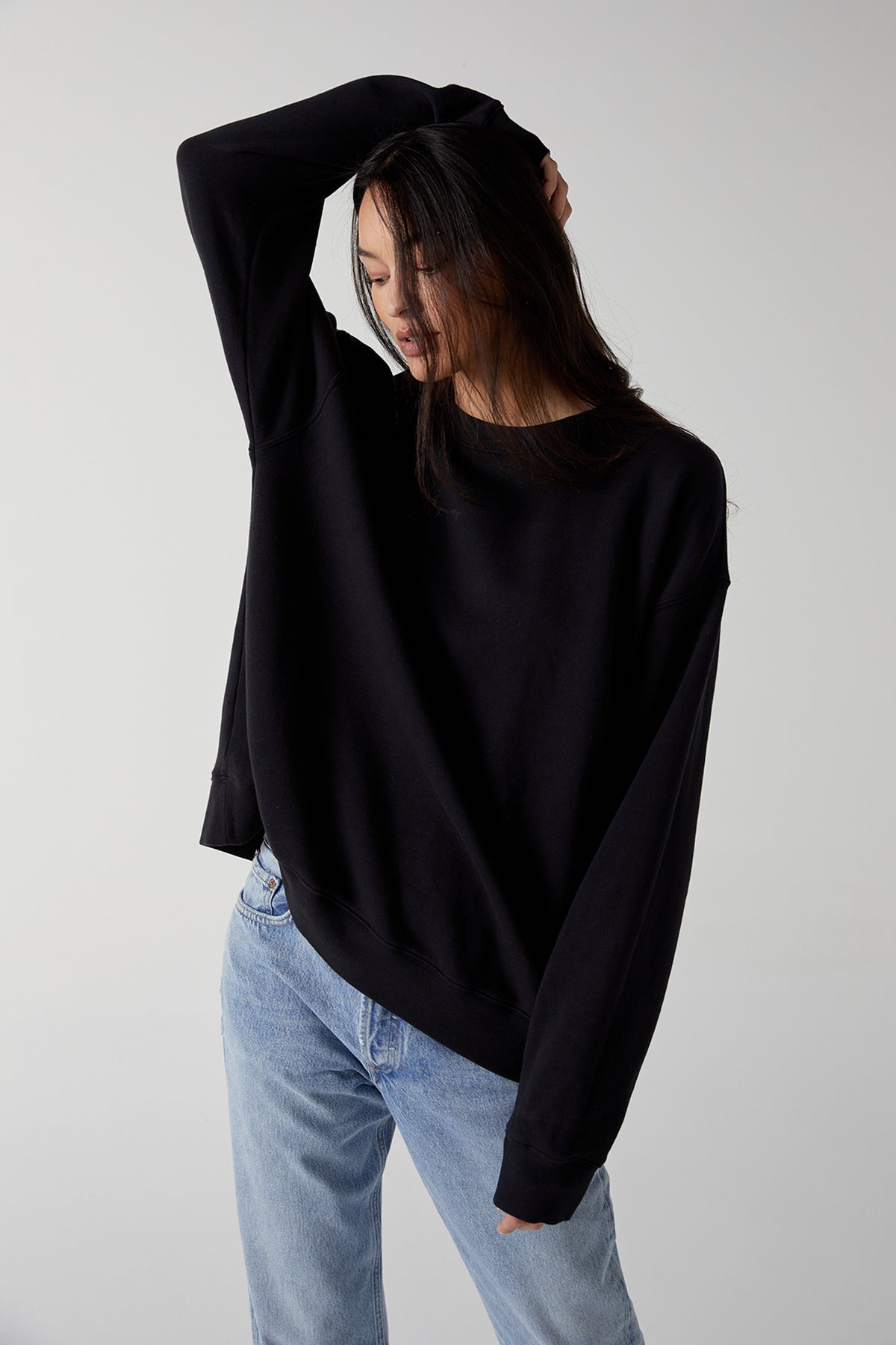 The model is wearing a black ABBOT SWEATSHIRT and jeans.-25483445829825