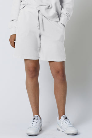 The model is wearing a Velvet by Jenny Graham LAGUNA SWEATSHORT and white shorts.