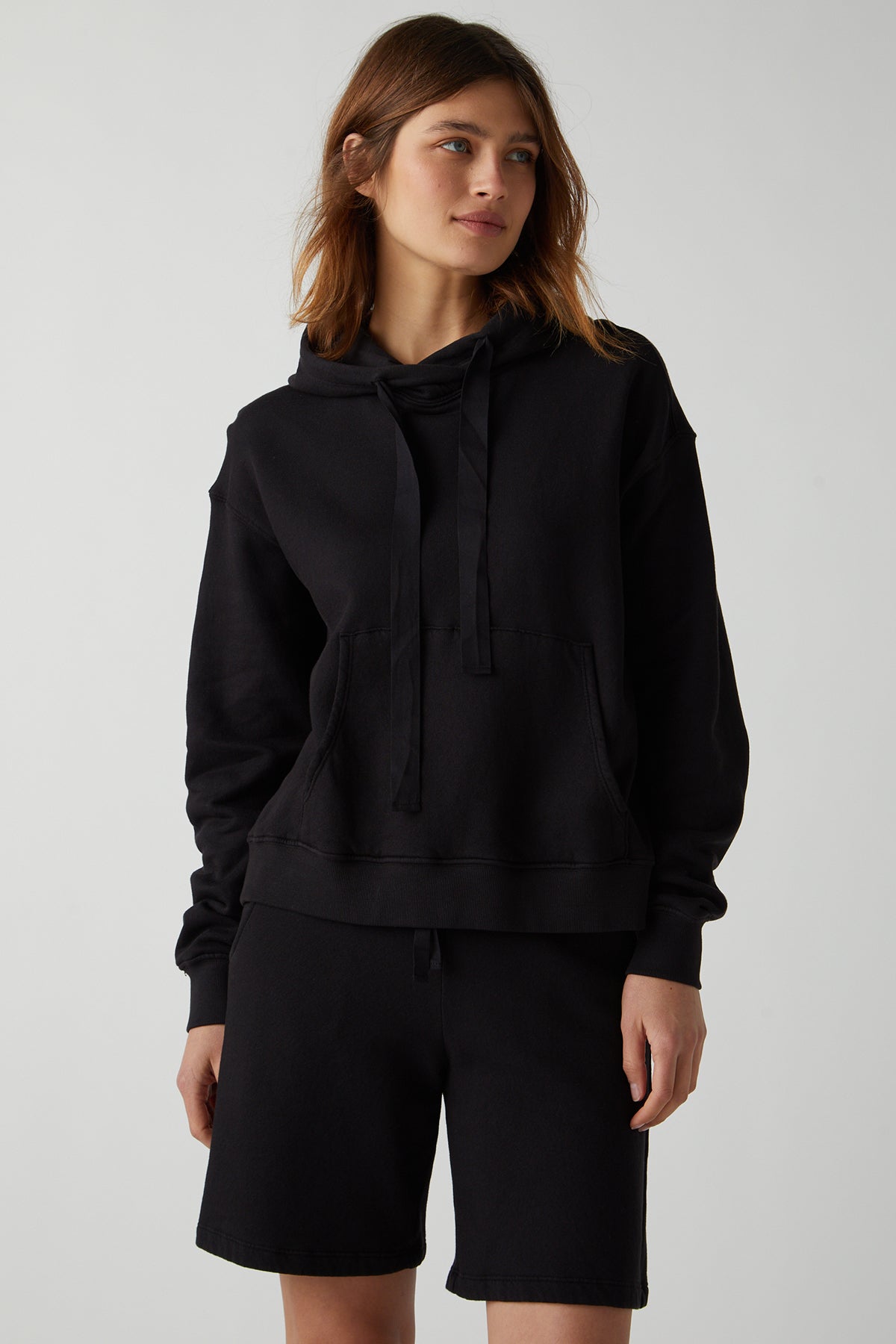 a woman wearing a Velvet by Jenny Graham LAGUNA SWEATSHORT hoodie and shorts.-26019352707265