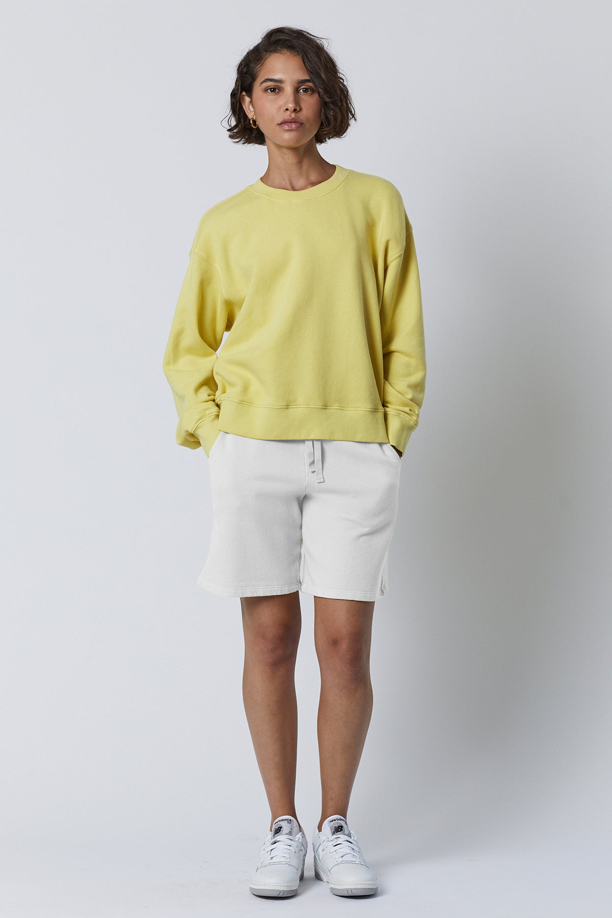   The model is wearing a Velvet by Jenny Graham LAGUNA SWEATSHORT and white shorts. 
