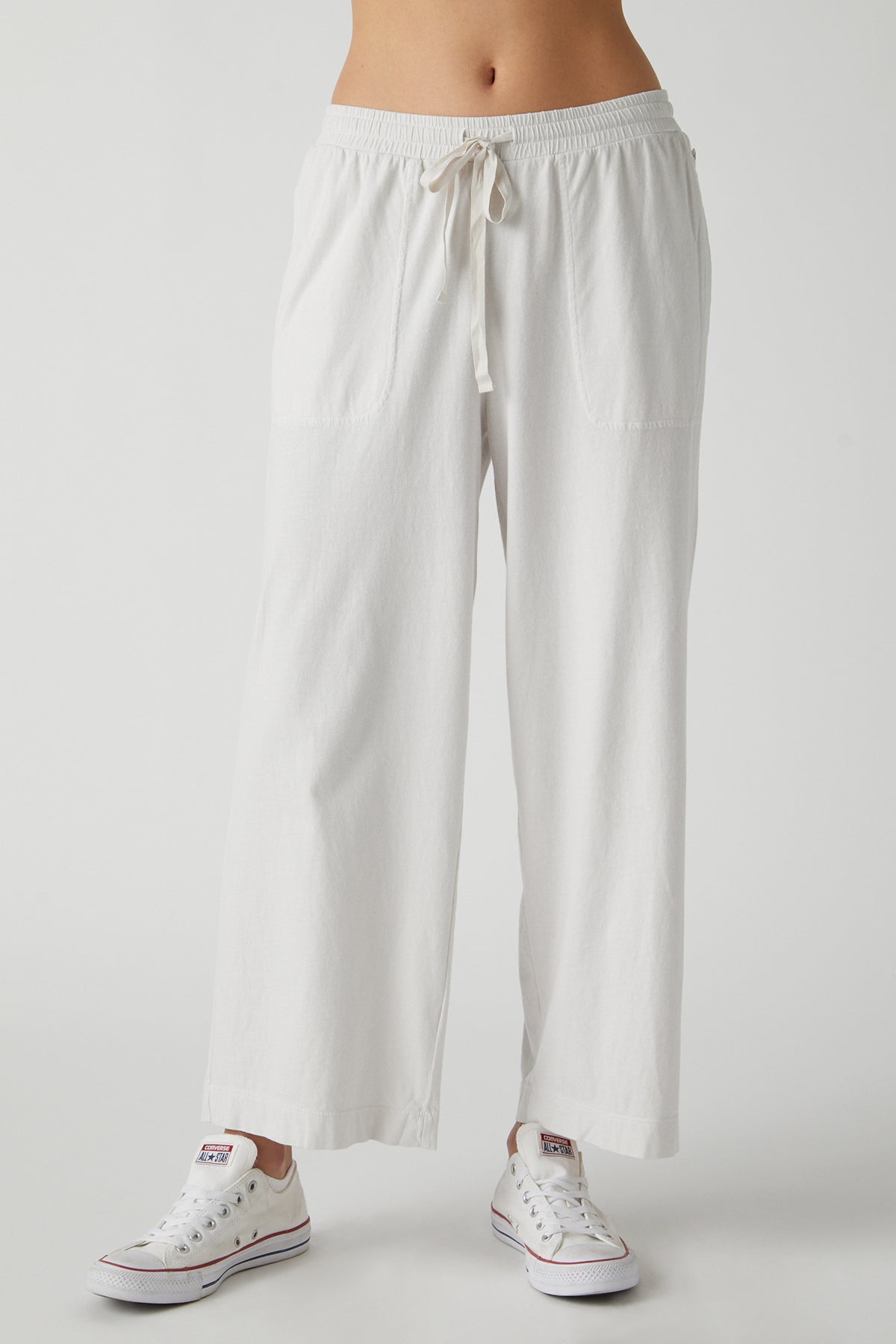   A woman wearing a white Velvet by Jenny Graham PISMO PANT. 